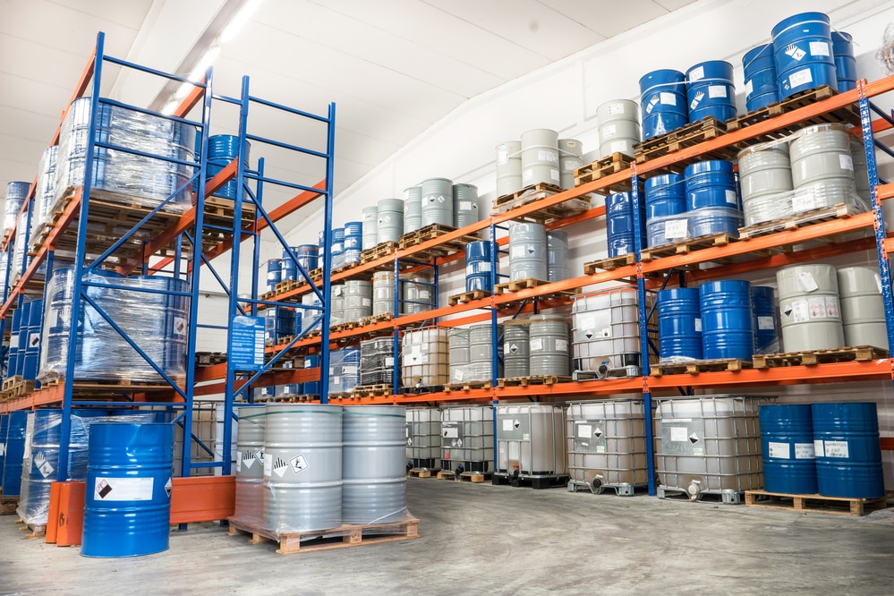 Metal chemical drums in industrial warehouse